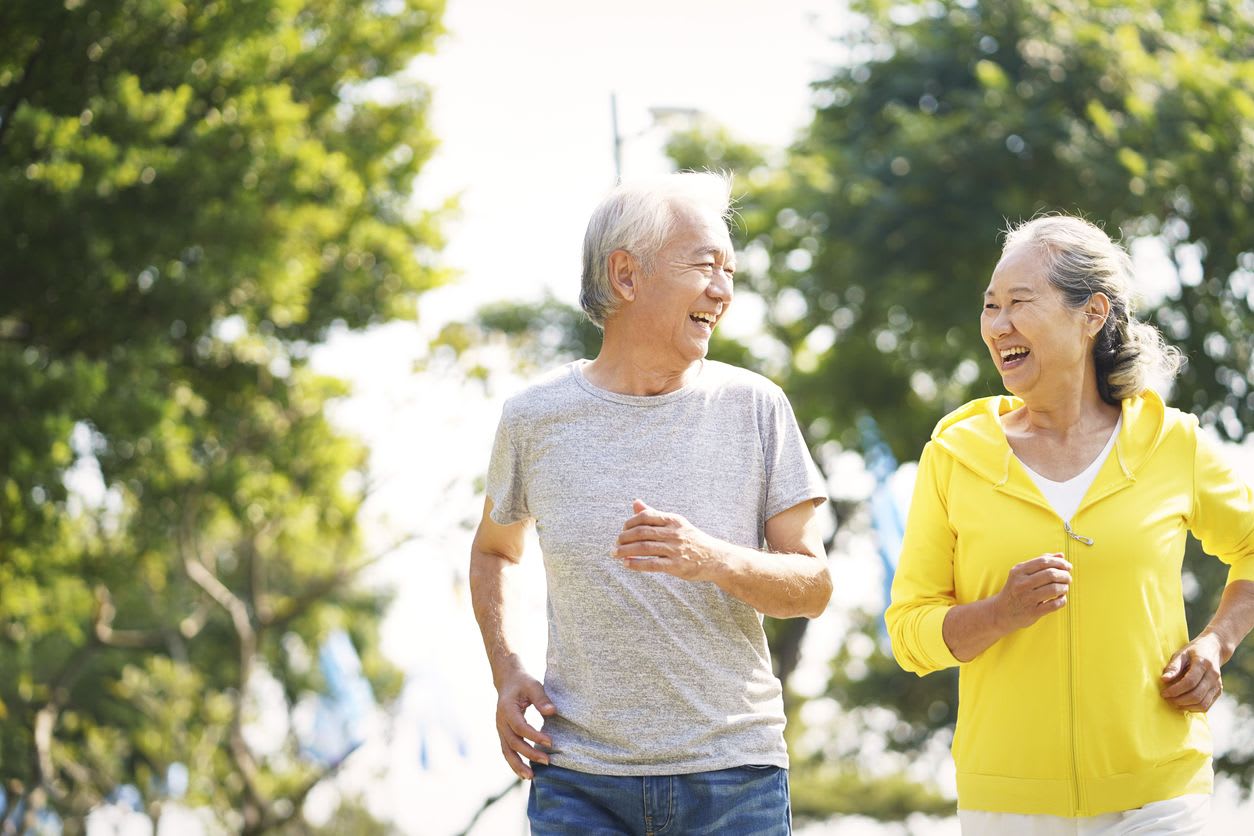 An older couple walking together outdoors