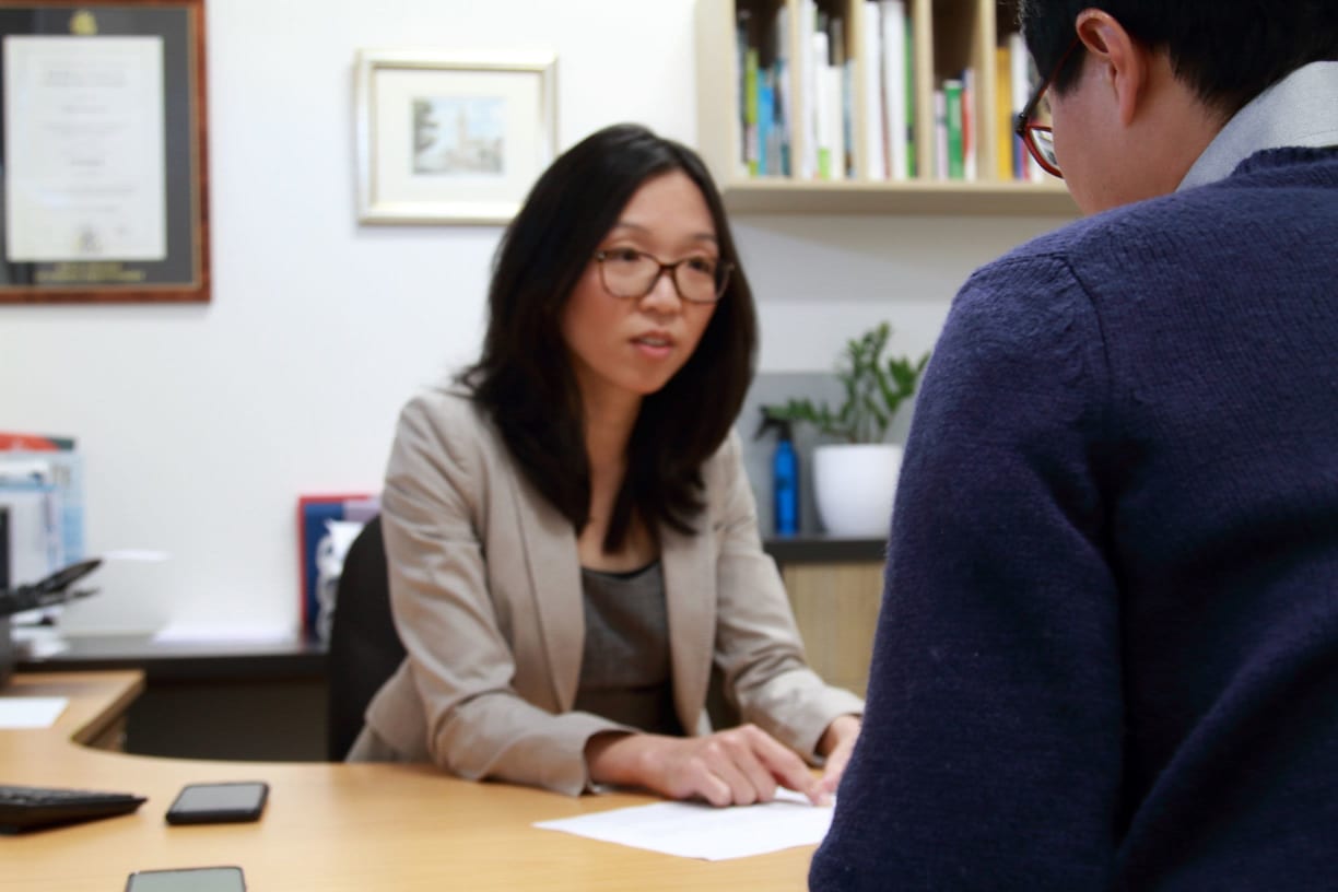 Professional woman talking to man seated across table