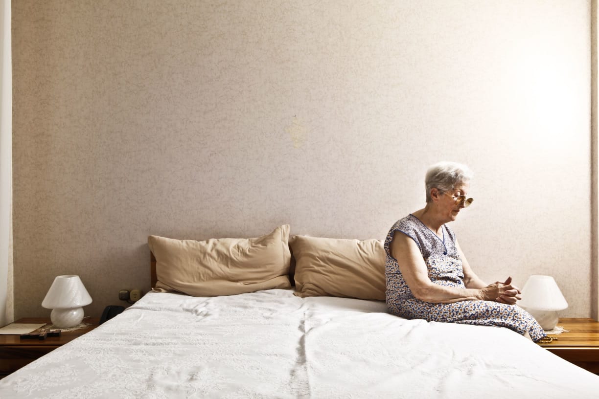 Person sitting on a bed